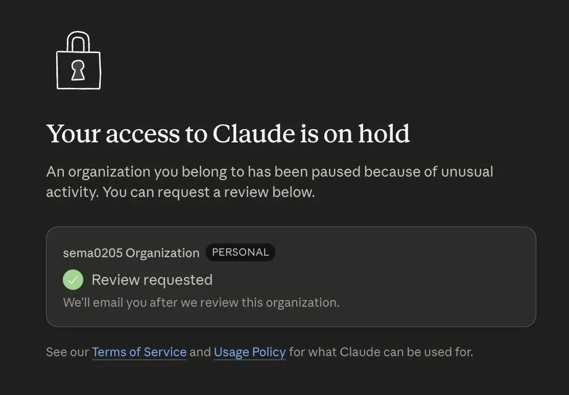 A Claude account suspension notice reading "Your access to Claude is on hold," explaining that an organization the user belongs to has been paused because of unusual activity.